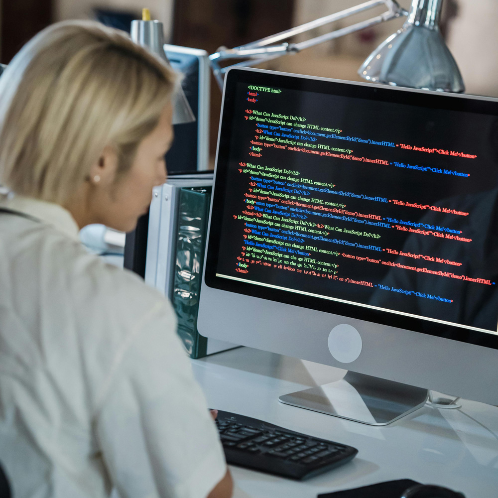 Woman on computer coding