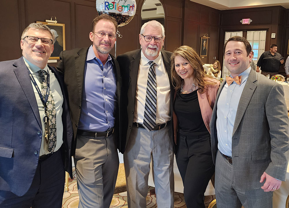 Group photo of PE Systems team celebrating Jack Grady's retirement