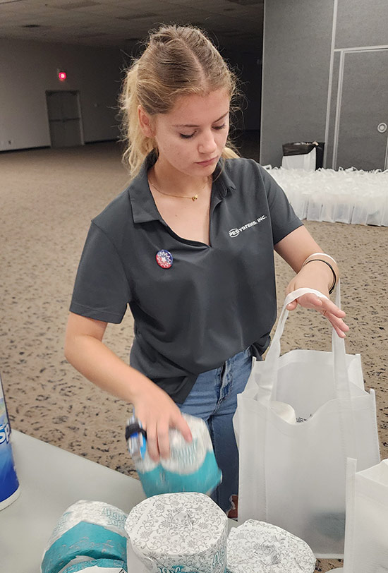 PE Systems intern, Brianna, packing bags for a community service event.