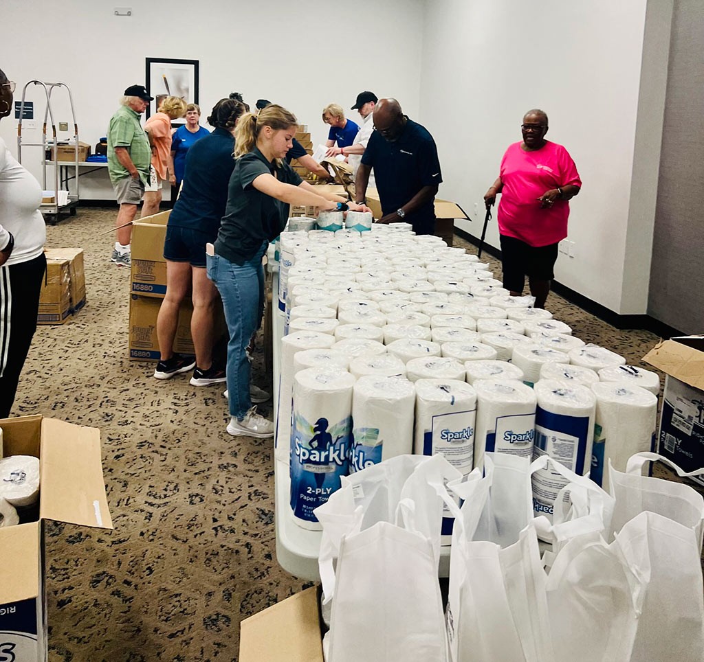 PE Systems volunteers assembling donation packages