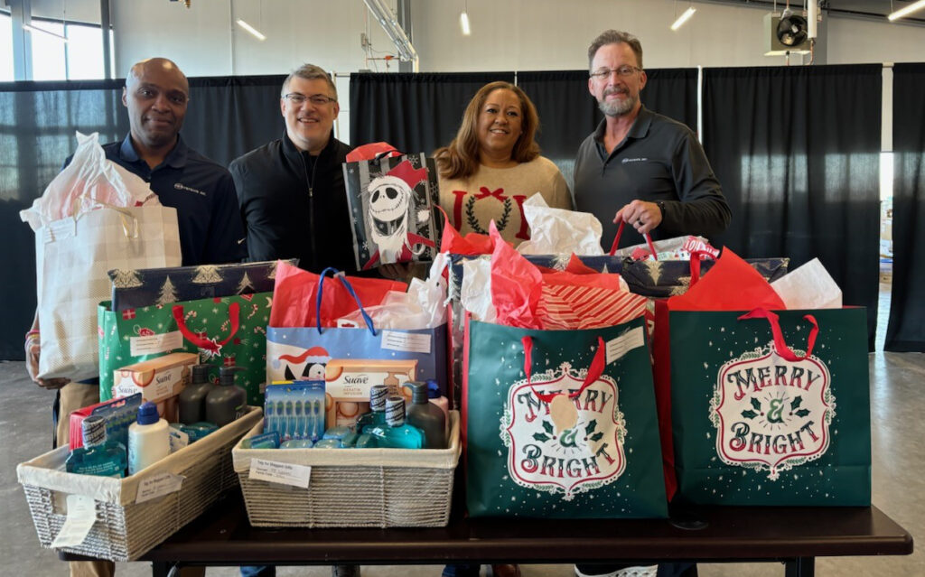 PE Systems team with a collection of gifts ready for donation