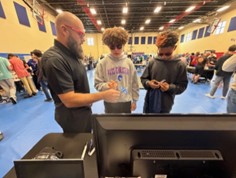 A person speaking to students.