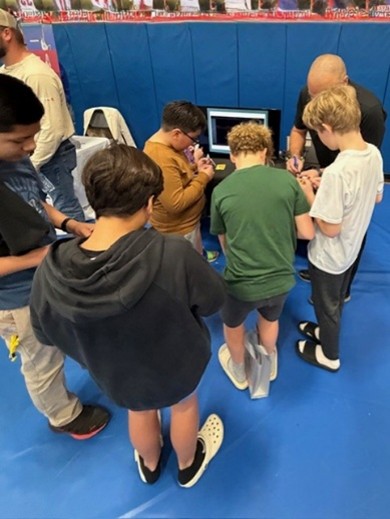 Students standing in front of a model aircraft .