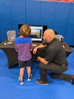 Scotty Myers and a student in front of a model aircraft